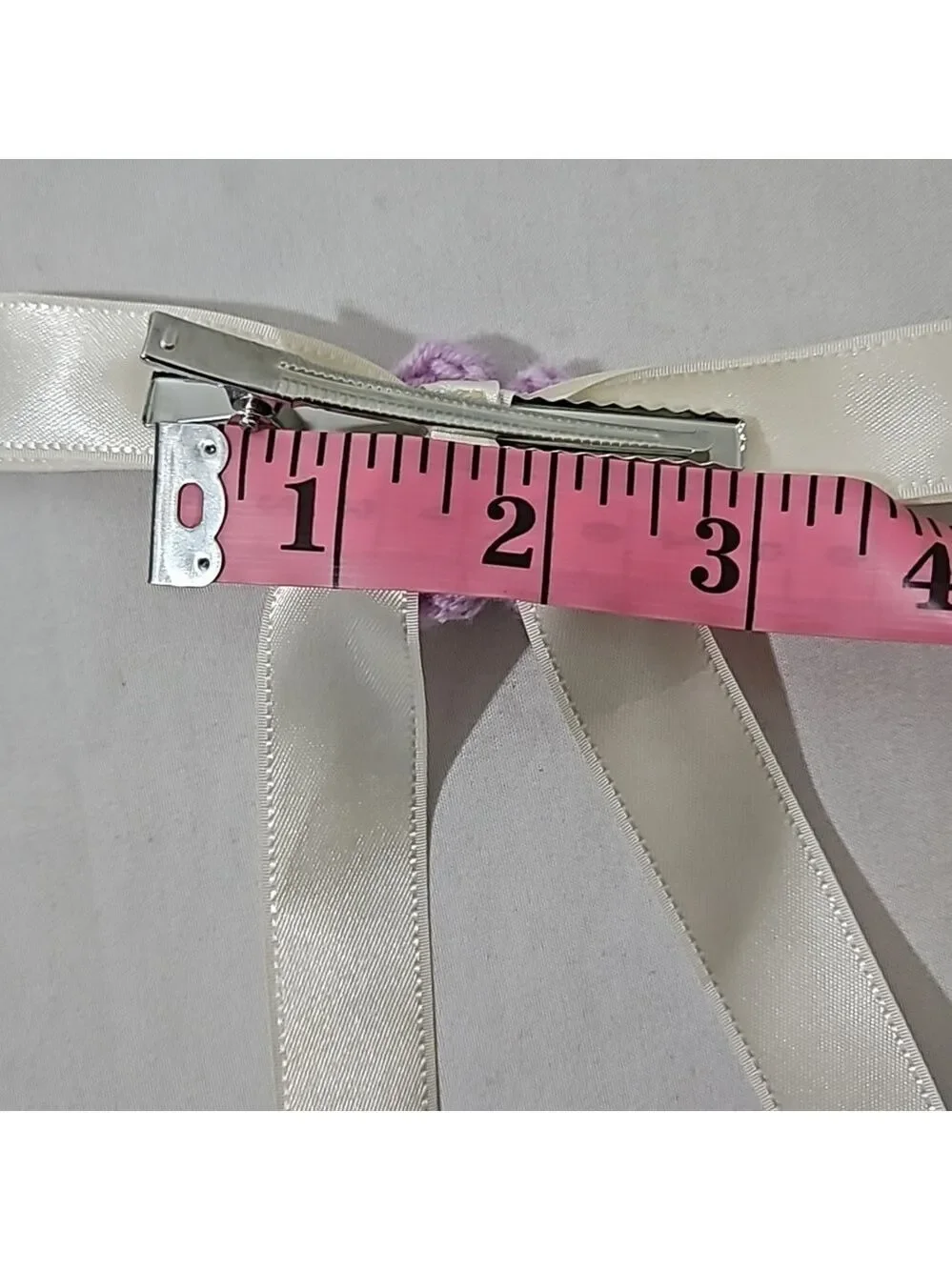 Hand Crafted Ivory Bow with Purple Crochet Flower